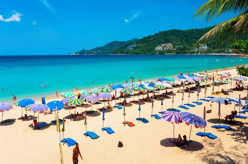 Playa de Patong en Phuket con arena dorada y hamacas y sombrillas